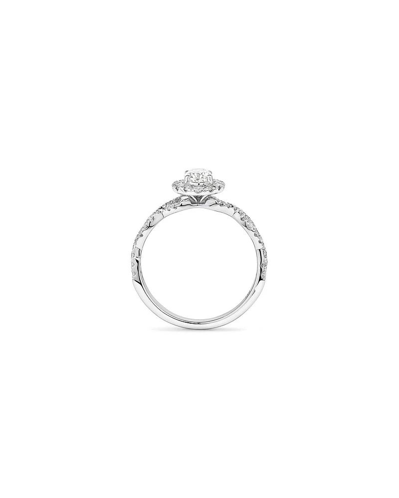 0.75 Carat TW Oval Cut Diamond Twist Side Accent Halo Engagement Ring in 14kt White Gold