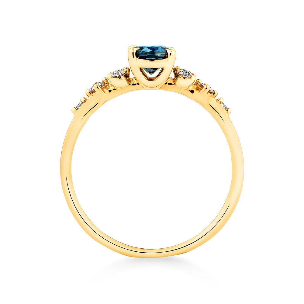 Ring with Blue Topaz and 0.12 Carat TW of Diamonds in 10kt Yellow Gold