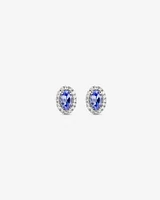 Oval Cut Blue Tanzanite Gemstone and 0.12 Carat TW Diamond Halo Stud Earrings in 10kt White Gold