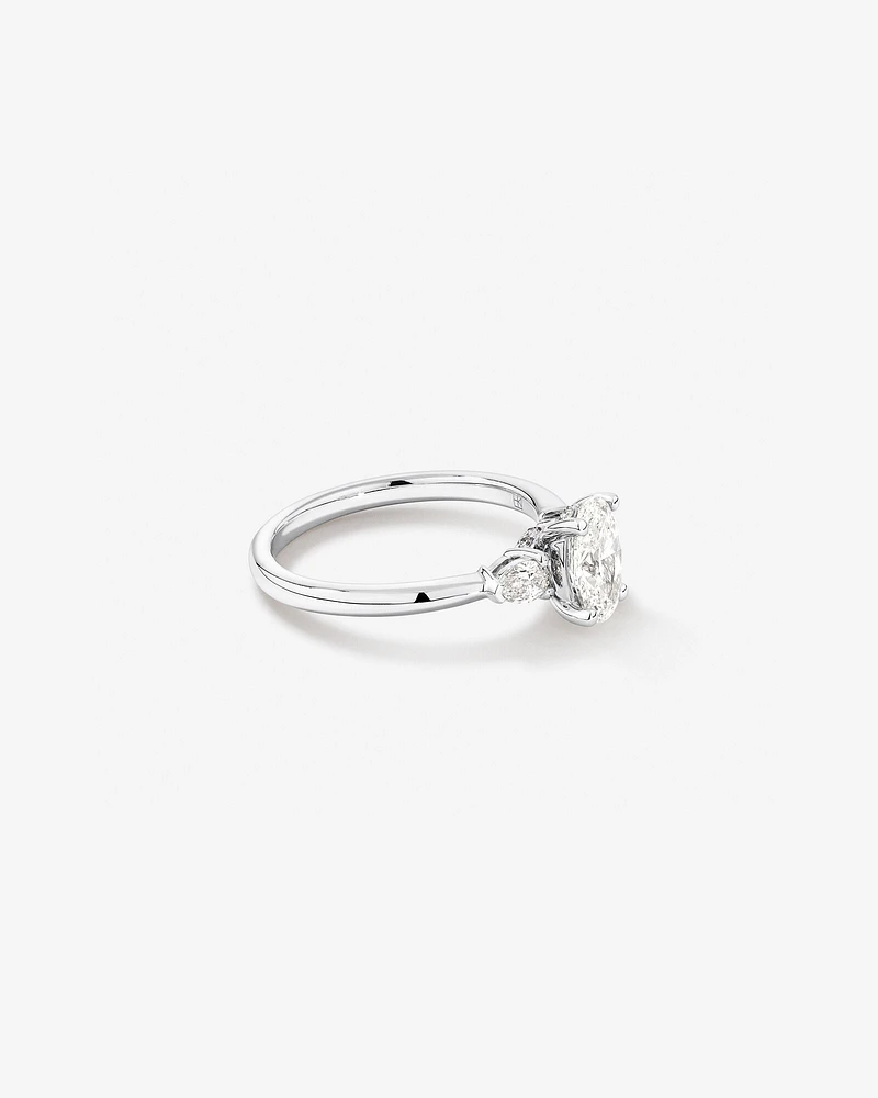 1.10 Carat TW Three Stone Oval and Pear Hidden Halo Engagement Ring in Platinum