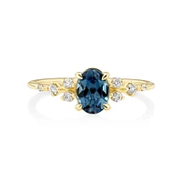 Ring with Blue Topaz and 0.12 Carat TW of Diamonds in 10kt Yellow Gold