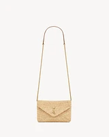 CASSANDRE chain pouch in raffia