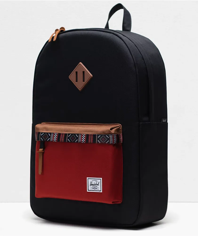 https://cdn.mall.adeptmind.ai/https%3A%2F%2Fscene7.zumiez.com%2Fis%2Fimage%2Fzumiez%2Fproduct_main_medium_2x%2FHerschel-Supply-Co.-Heritage-Black%252C-Saddle-Brown-%2526-Ketchup-Backpack-_174417-alt2-CA.jpg_large.webp