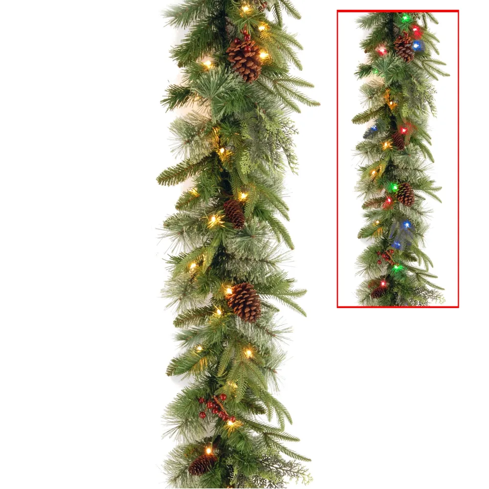 National Tree 9' x 10" Feel Real(R) Colonial Garland with 15 Pine Cones, 15 Red Berries and 50 Dual Color(R) Battery Operated Led Lights with Timer