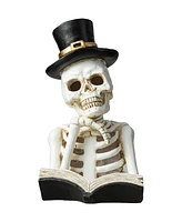 Glitzhome 10.25" H Halloween Lighted Resin Skull Reading Book Table Decor
