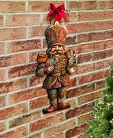 Designocracy Clara and Nutcracker Prince Christmas Door Hanger Wooden Door Decor G. DeBrekht