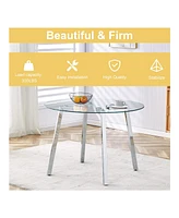 Table and chair set.a Modern Minimalist Style Round Clear Tempered Glass Table with silver Metal Legs.Paired with 6 chairs with Modern Pu Leather High