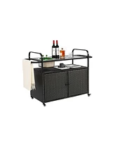 Black wicker outdoor bar cart with steel top, ice bucket, locking wheels, and side basket
