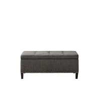 Modern tufted storage bench with soft-close lid, grey linen upholstery, button tufting, black wood legs, and interior for bedroom or entryway.