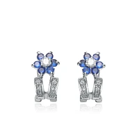 Genevive Sterling Silver White Gold Plating with Blue Cubic Zirconia Flower-Inspired Omega Back Earrings
