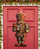 Designocracy Clara and Nutcracker Prince Christmas Door Hanger Wooden Door Decor G. DeBrekht