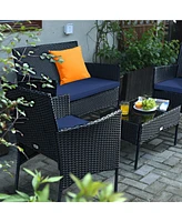 Sugift 4 Pieces Patio Rattan Cushioned Sofa Set with Tempered Glass Coffee Table-Navy & Off White