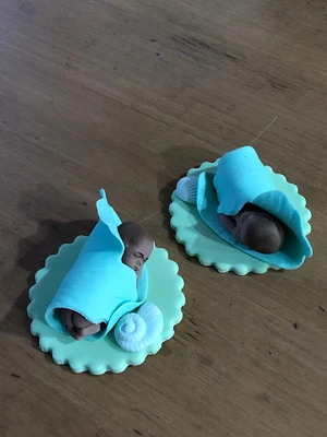 New born sleeping baby boy in blue flower petal