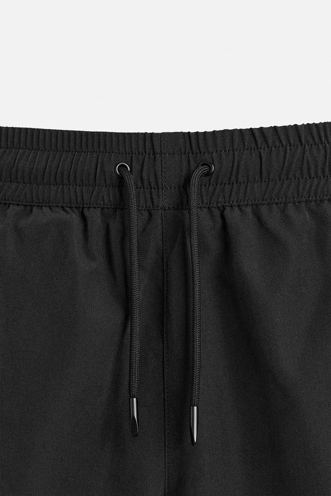 BASIC LONG SWIM TRUNKS