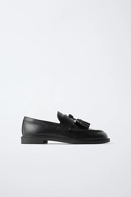 MOCASSINS À POMPONS