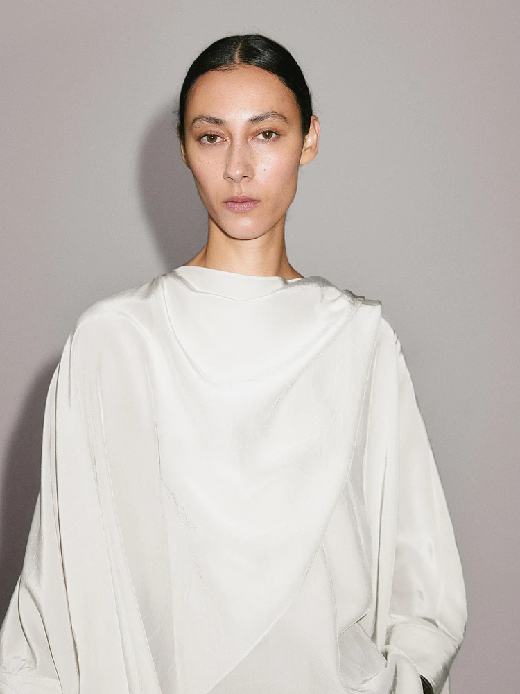 Short flowing cape with sleeve detail