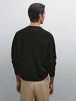 Cotton knit sweater with buttoned neck
