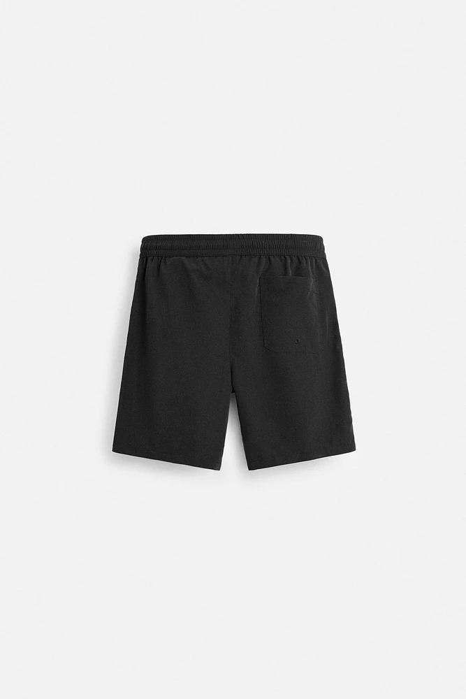 BASIC LONG SWIM TRUNKS