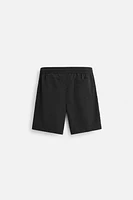 BASIC LONG SWIM TRUNKS