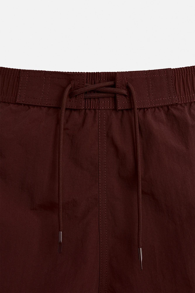 DRAWSTRING SWIM TRUNKS