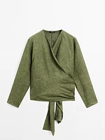 Flowing linen blouse with tie detail at the waist