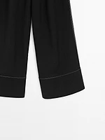 Flowing trousers with contrast topstitching