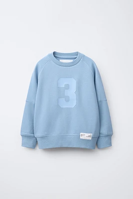 RAISED NUMBER SWEATSHIRT