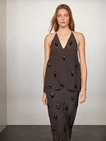 Flowing trousers with floral appliqués