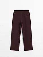 Flowing trousers with darts and thin waistband