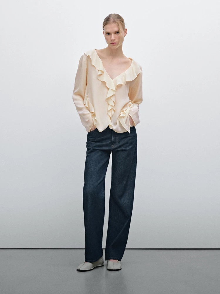 Ruffled blouse with asymmetric hem