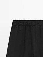 Flowing trousers with contrast topstitching