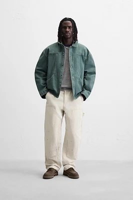 VESTE DÉLAVÉE SURPIQÛRES CONTRASTÉES