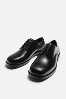 CHAUSSURES EN CUIR HABILLÉES
