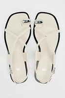 FLAT STRAPPY SANDALS WITH METAL ORNAMENT