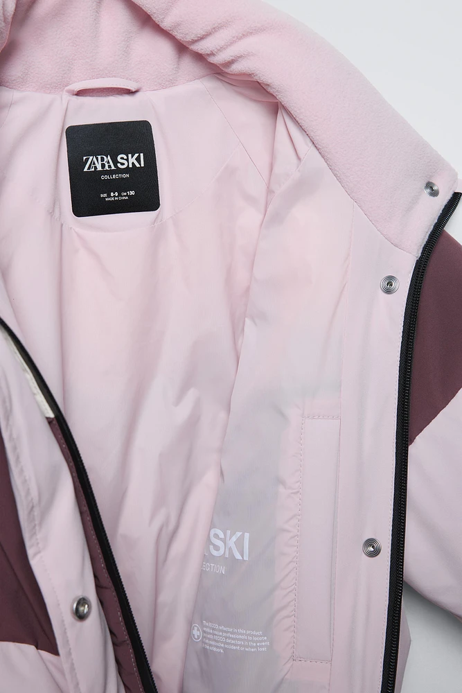 COMBINAISON DE SKI EN PLUMES COUPE-VENT ET DÉPERLANTE RECCO® SYSTEM