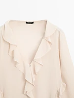 Ruffled blouse with asymmetric hem