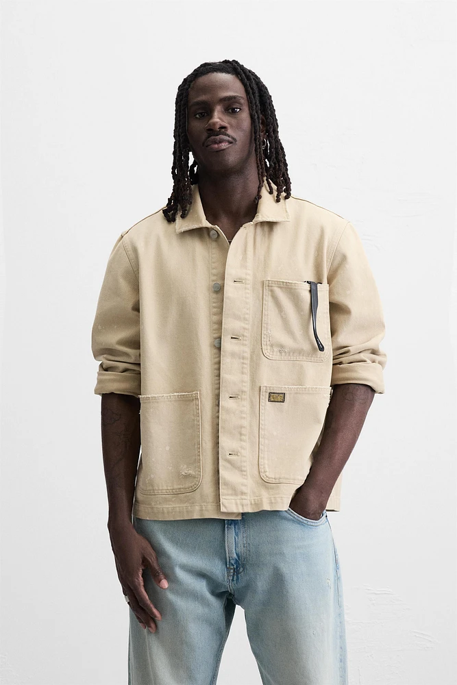 VESTE DÉLAVÉE À ÉCLABOUSSURES