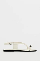 FLAT STRAPPY SANDALS WITH METAL ORNAMENT