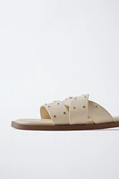 STUDDED CROSSOVER FLAT SANDALS