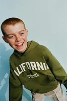 RAISED TEXT SWEATSHIRT