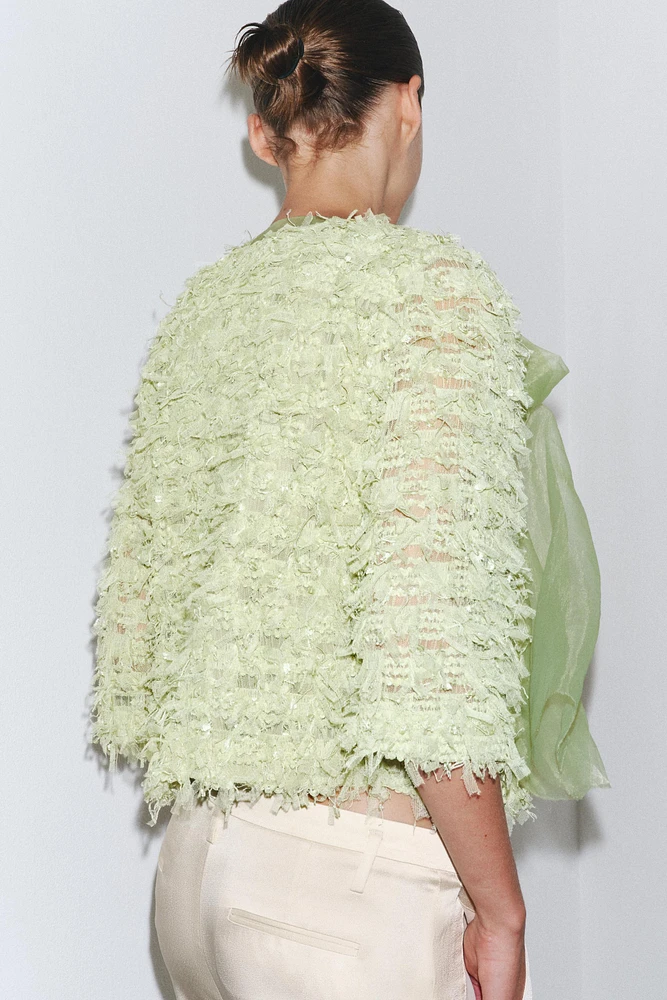 GILET EN MAILLE À FRANGES AVEC LACET ORGANZA