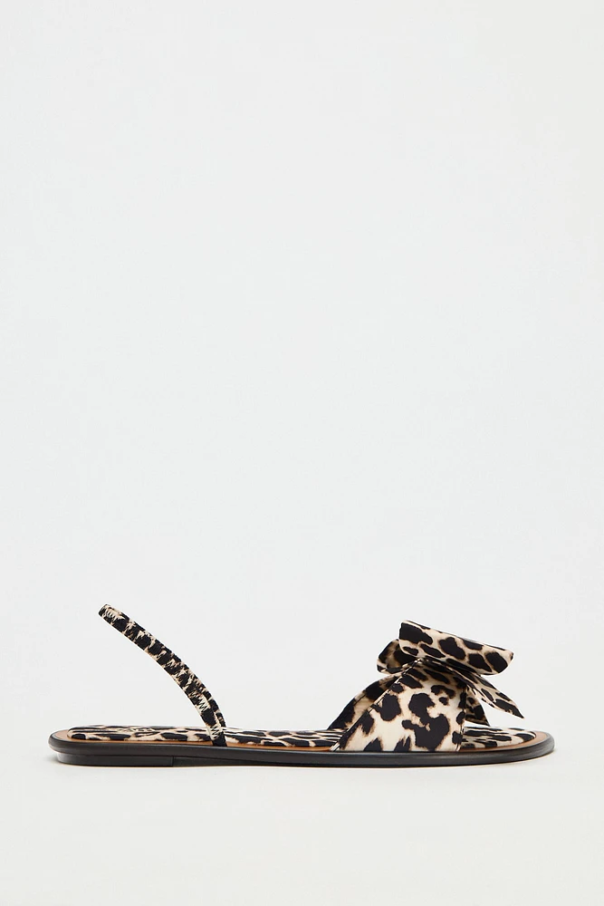 ANIMAL PRINT BOW FLAT SANDALS