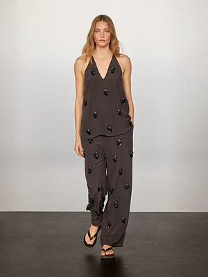 Flowing top with floral appliqués