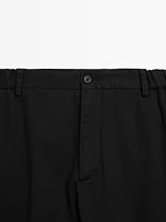 Tapered fit trousers with side elastic detail