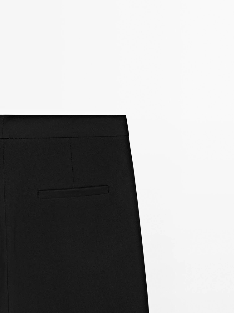 Trousers with buttoned hems