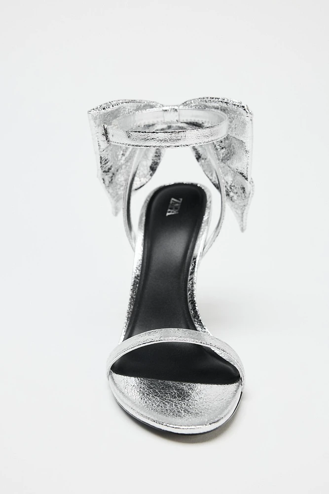METALLIC EFFECT BOW SANDALS