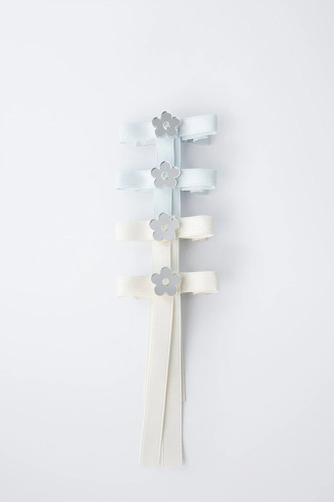 PACK OF FOUR BOW HAIR CLIPS WITH FLOWER