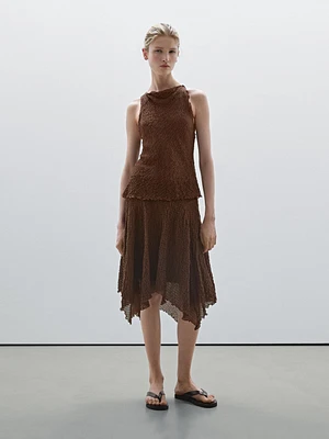 Flowing check skirt with asymmetric hem