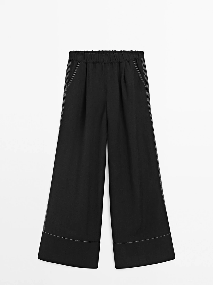 Flowing trousers with contrast topstitching