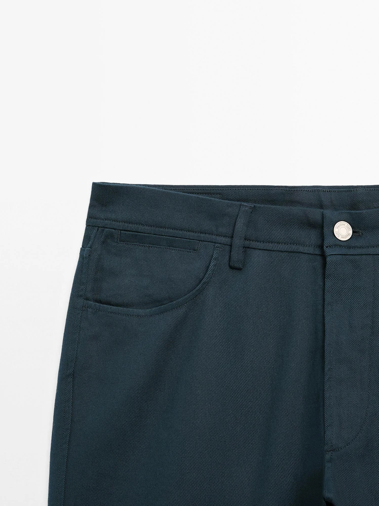 Faux jean tapered fit en coton mélangé